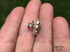 Dragon lapel pin side view in hand