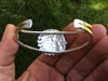 Chief Bracelet large carving back view in hand