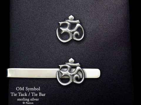 Om tie tack or tie bar shown on tie (front view)