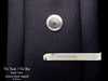 Om tie tack or tie bar on tie (back view)