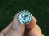 Sun Wave Tie Tack in hand